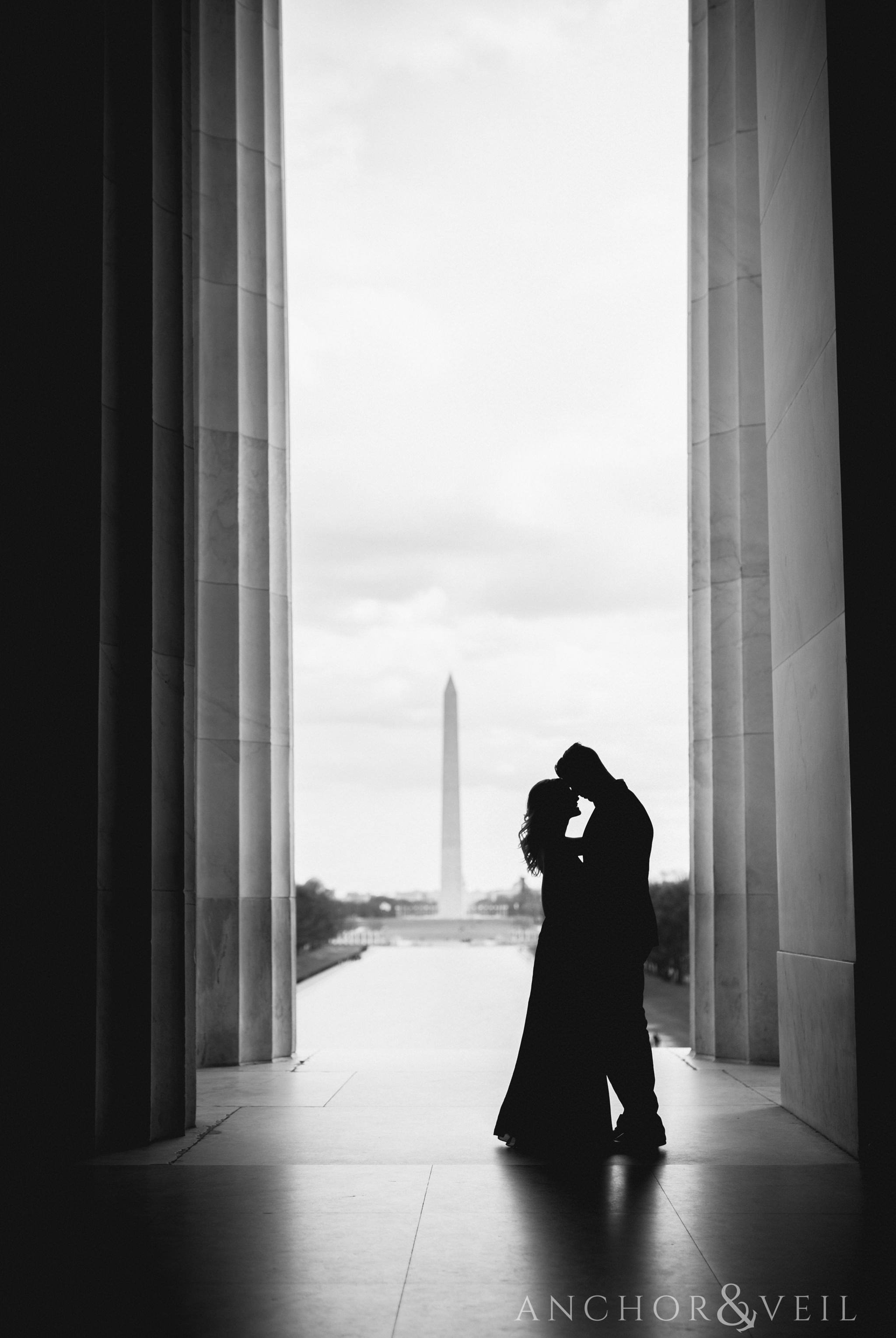 silhouette from Lincoln memorial with the Washington monument during their Scenic Washington DC Engagement Session