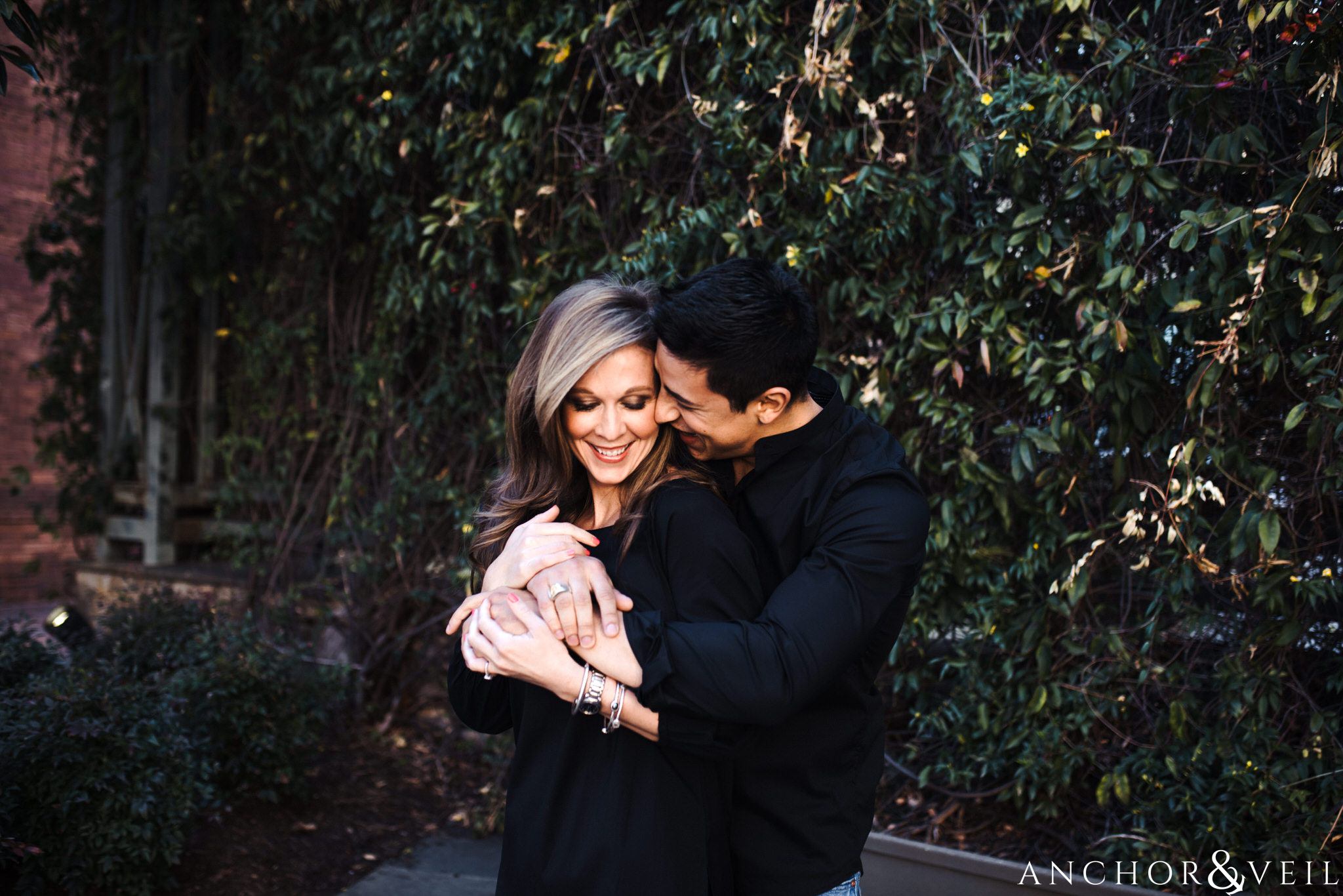Holding her tight in the Ivy During their Uptown Charlotte Engagement Session