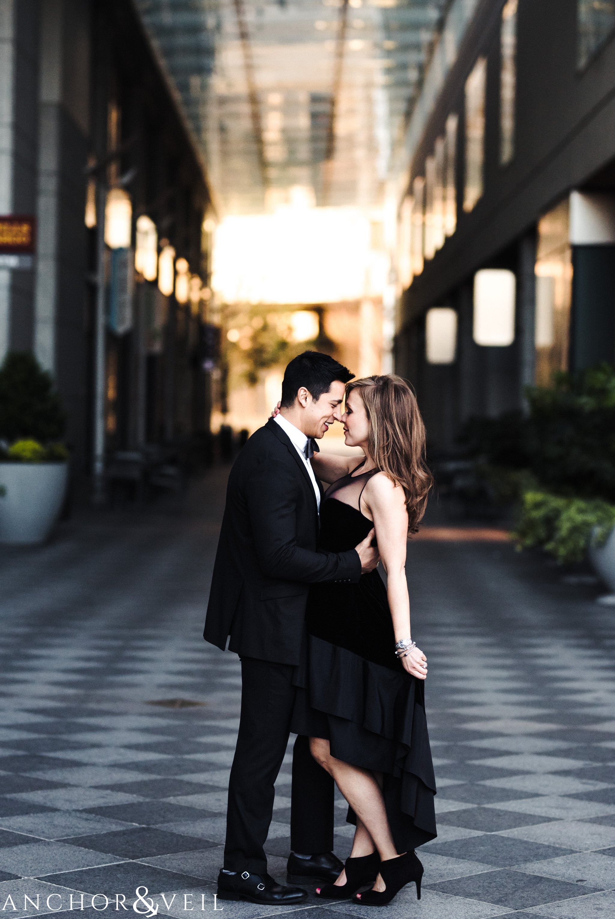 in the walkway During their Uptown Charlotte Engagement Session