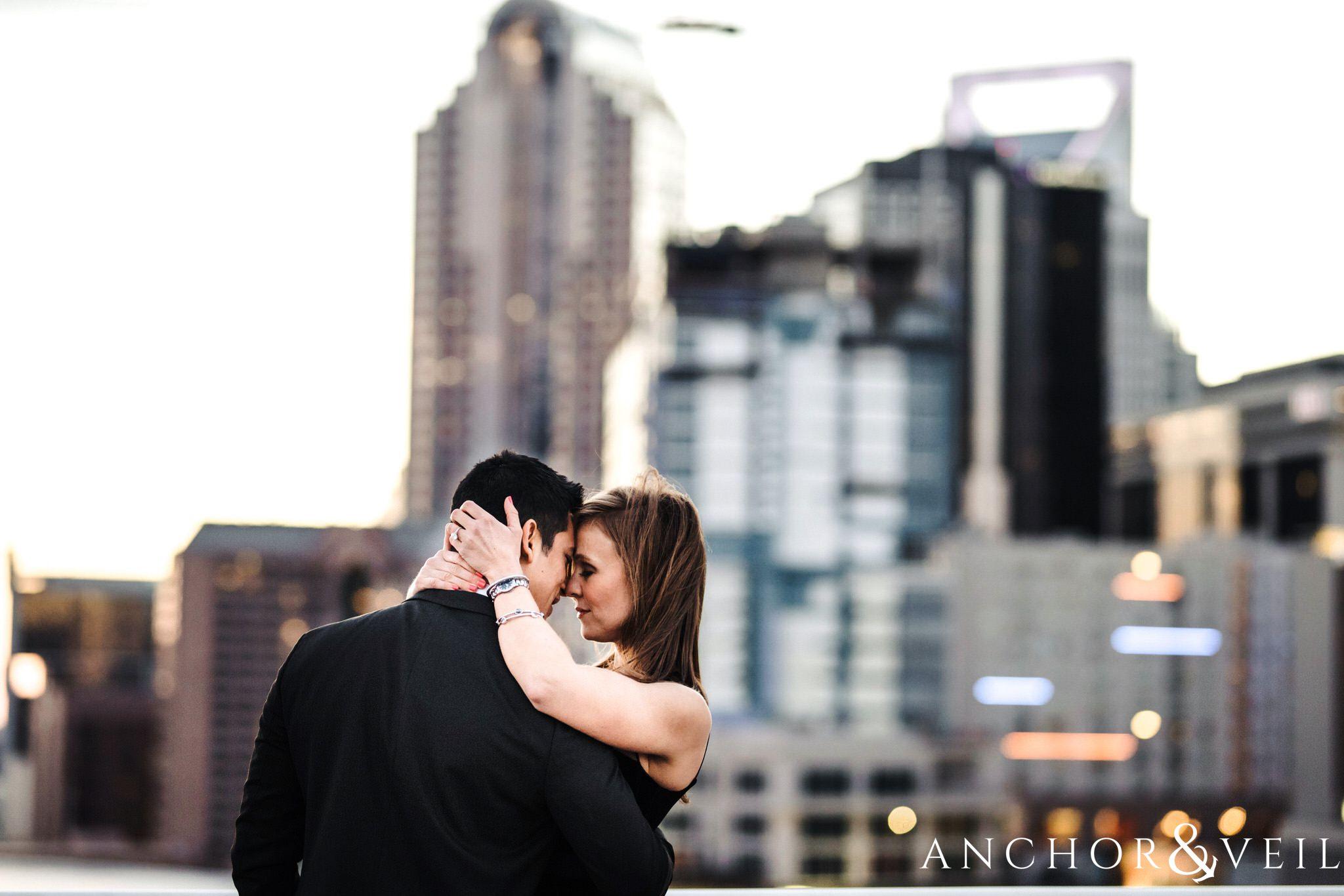 Charlotte skyline During their Uptown Charlotte Engagement Session