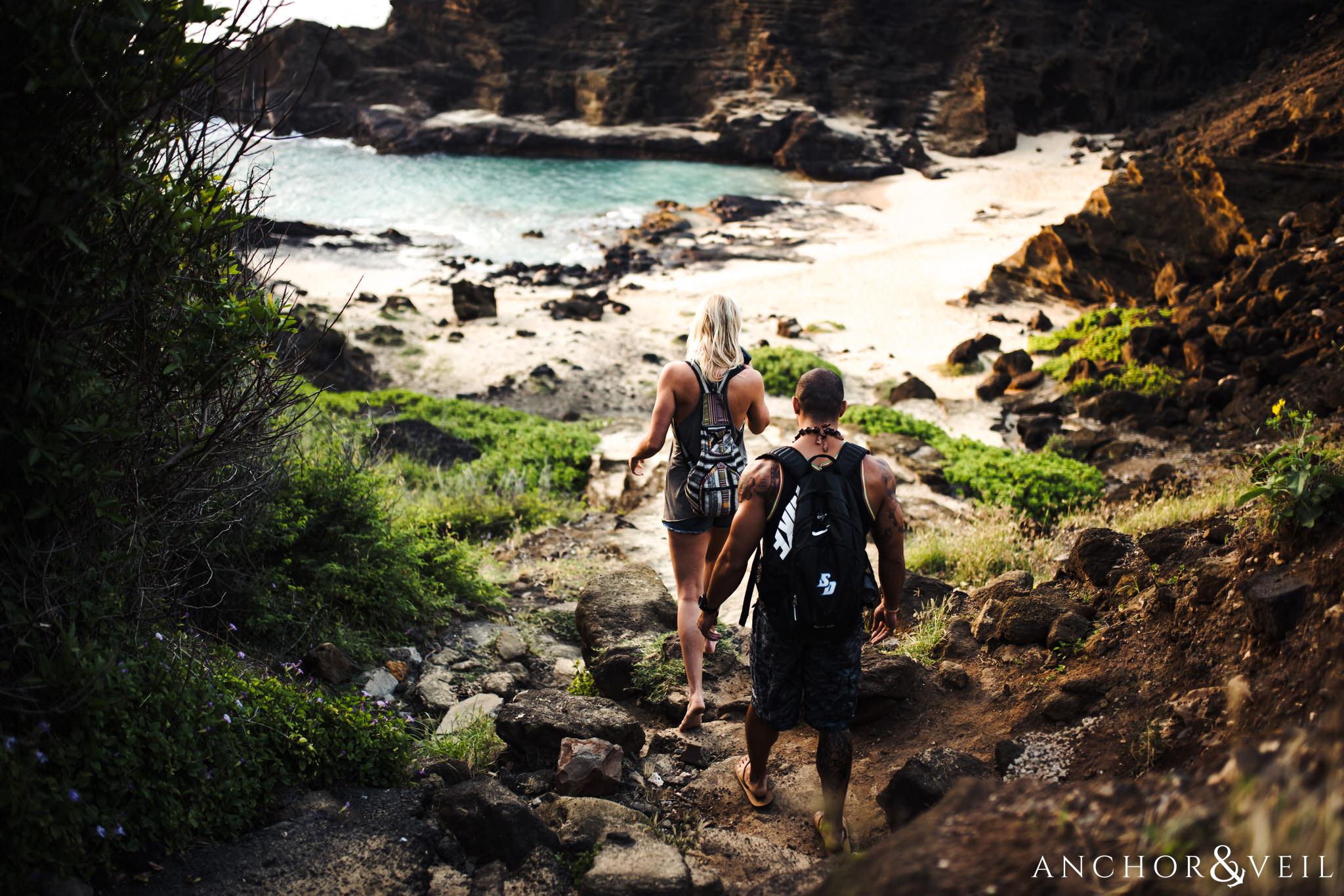 Walking down the path during their Eternity Beach Session in Honolulu Hawaii Halona Cove