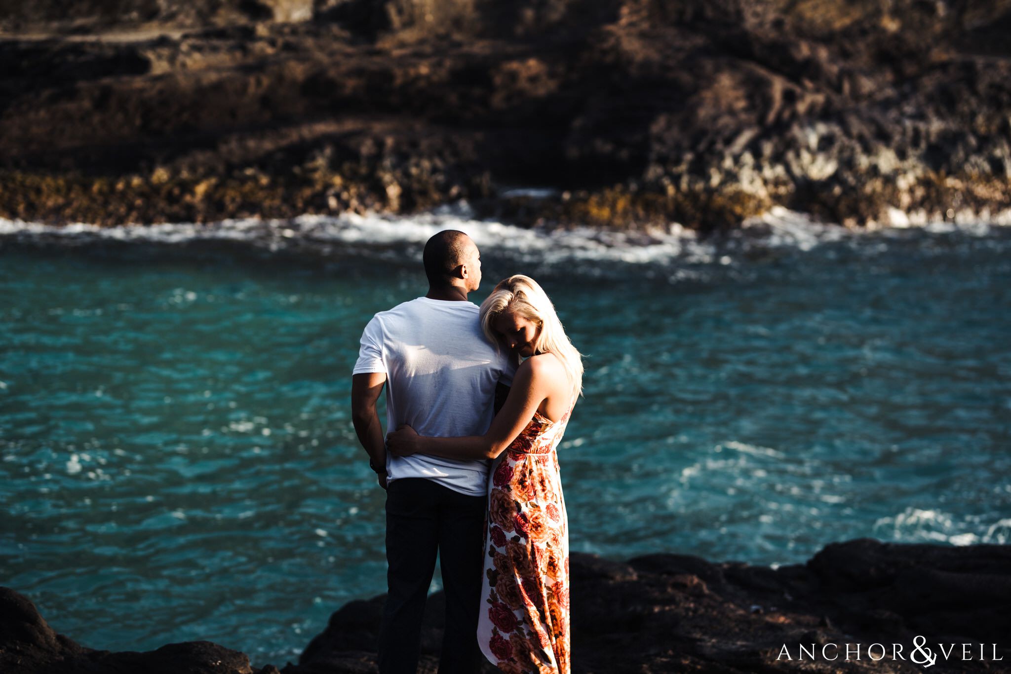 standing near the water during their Eternity Beach Session in Honolulu Hawaii Halona Cove