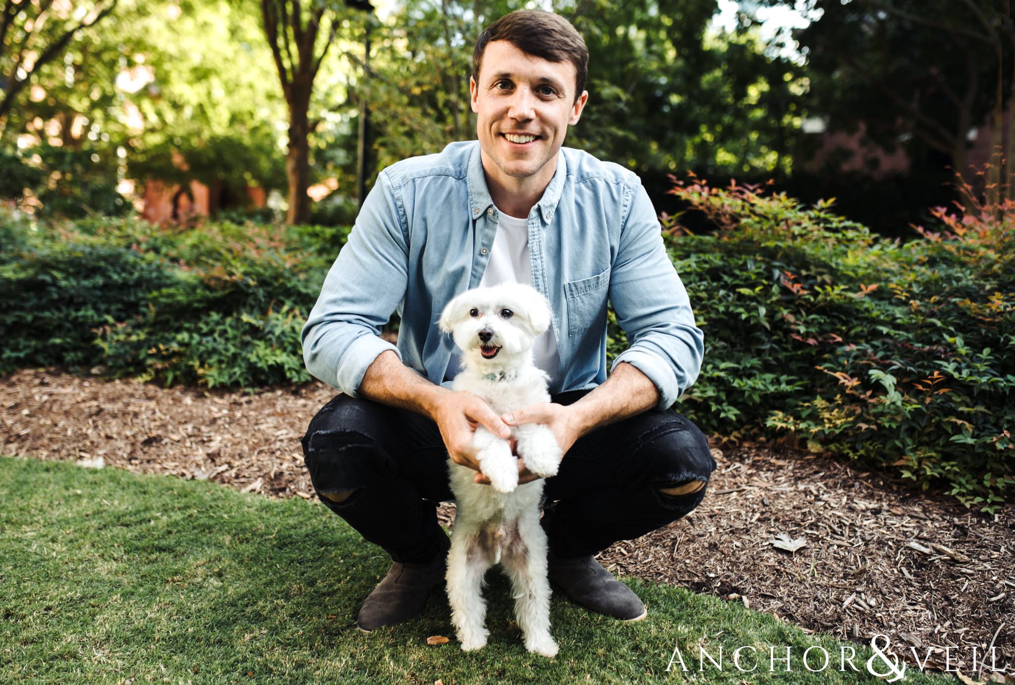 holding the dog during the uptown Charlotte engagement session
