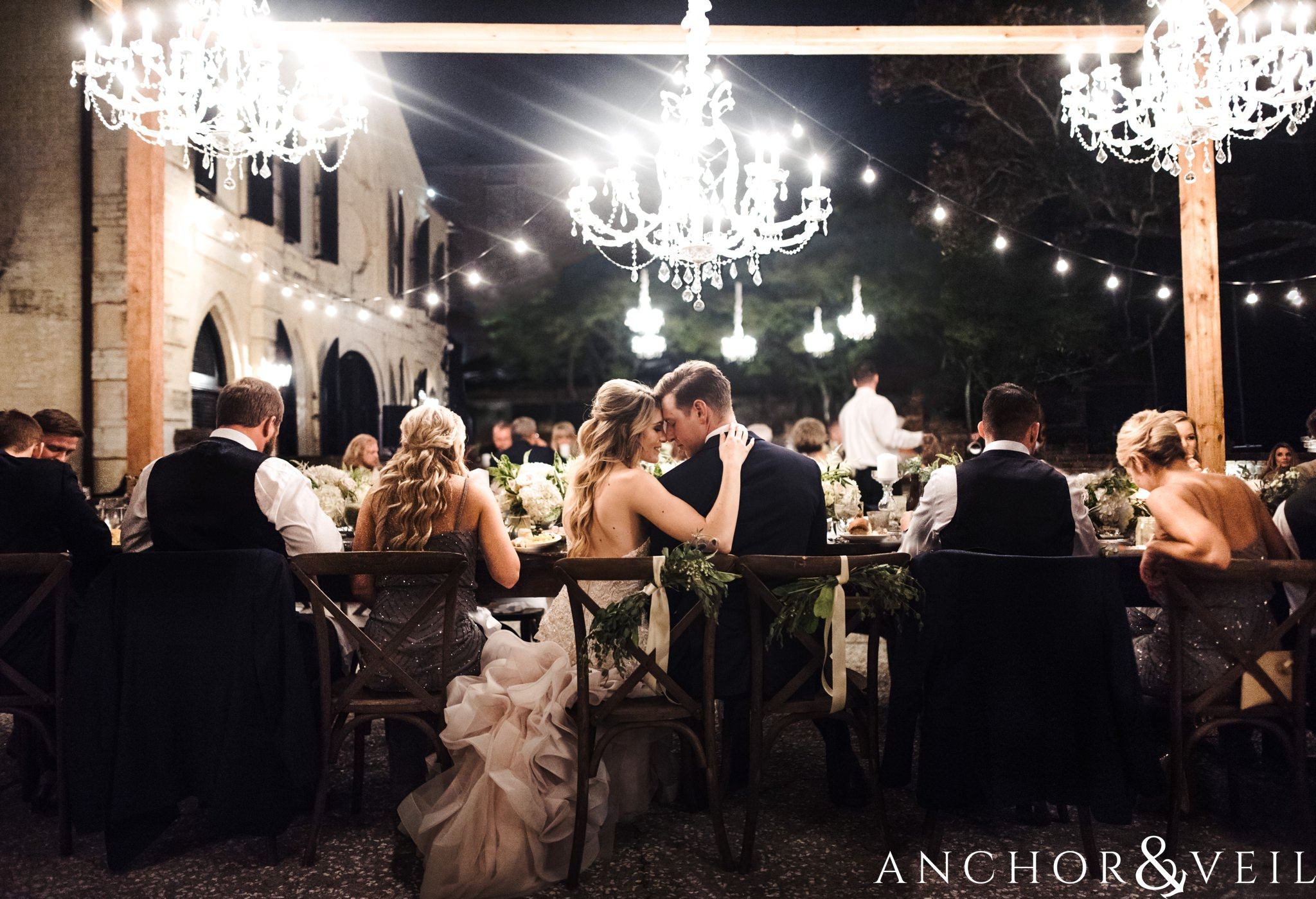 bride with chandeliers during reception during their William Aiken house Wedding in Charleston Sc