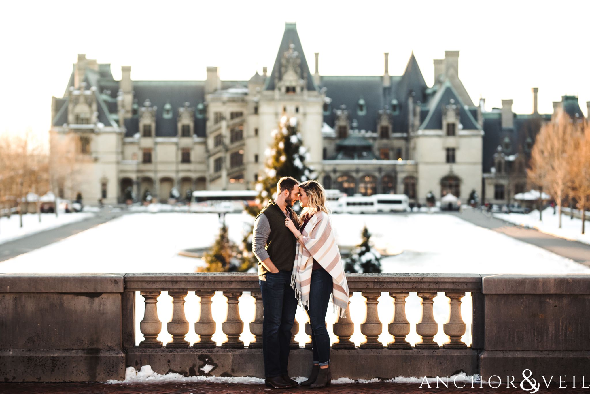 ni front of the house during their Snowy Biltmore Engagement Session