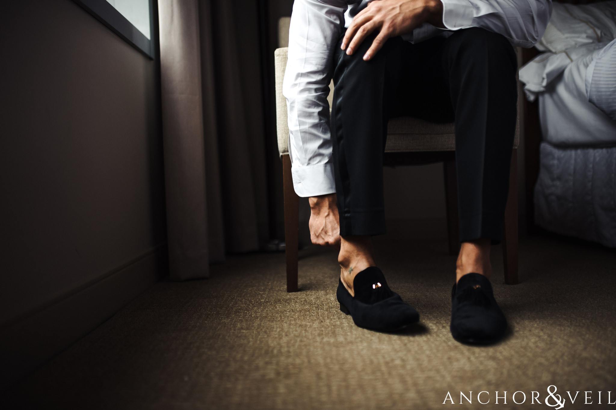 Putting on shoes at the Westin during their New Years Even uptown Charlotte Wedding