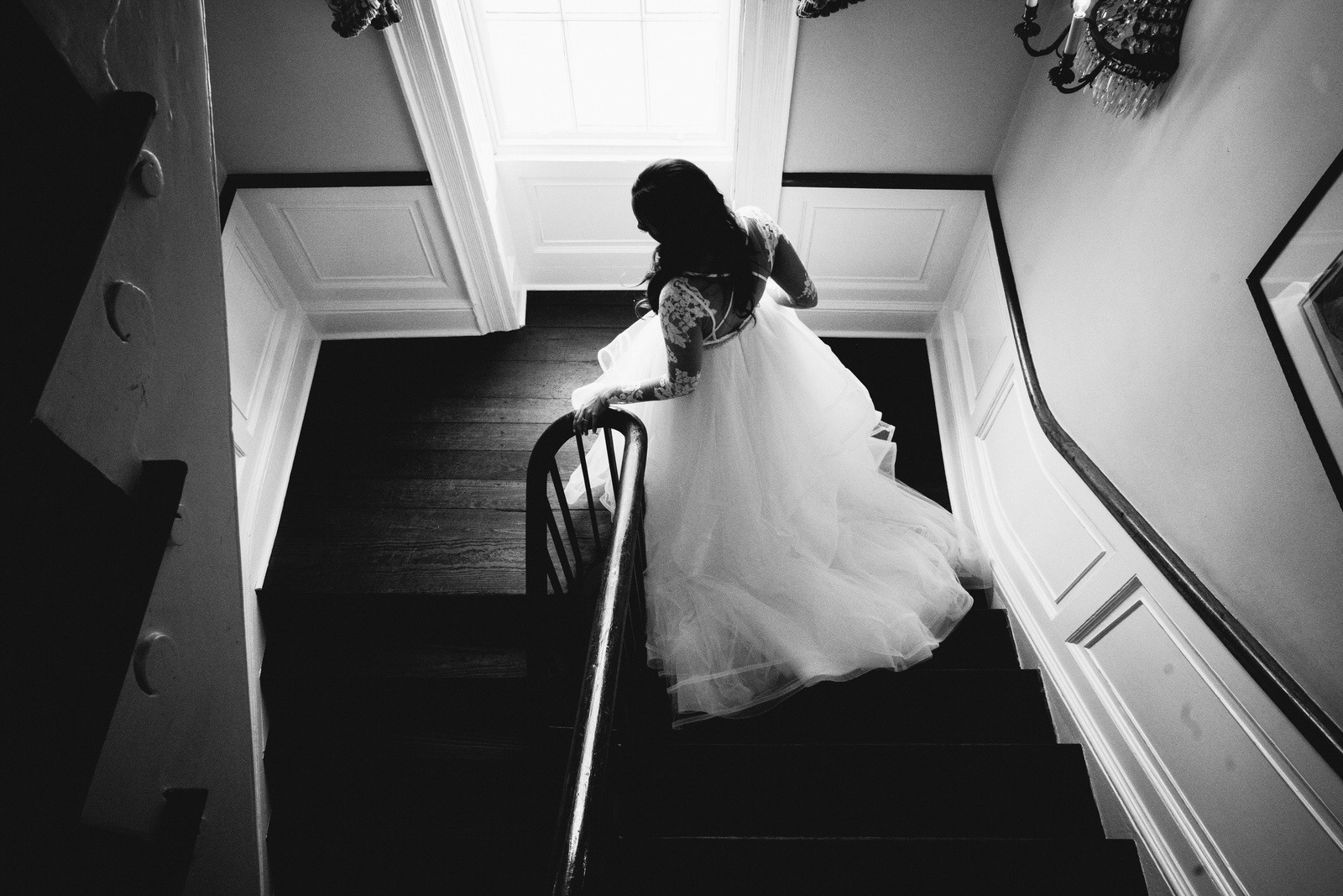 bride walking down the stairs during their William Aiken house Wedding