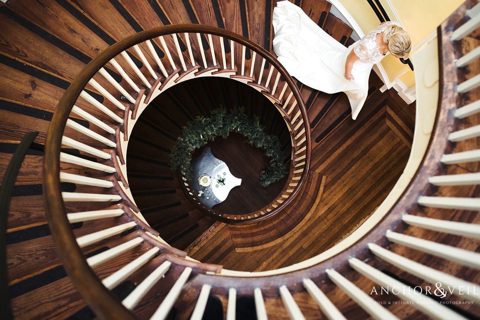 Walking down the spiral staircase at the Lowndes Grove Plantation Wedding