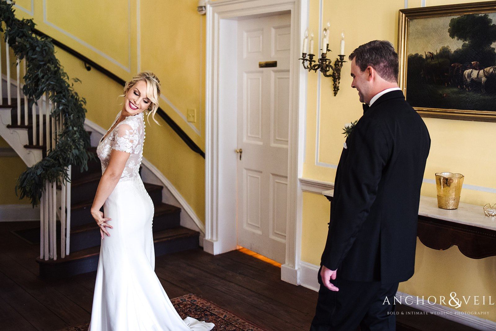 The groom admiring his bride in her dress at the Lowndes Grove Plantation Wedding