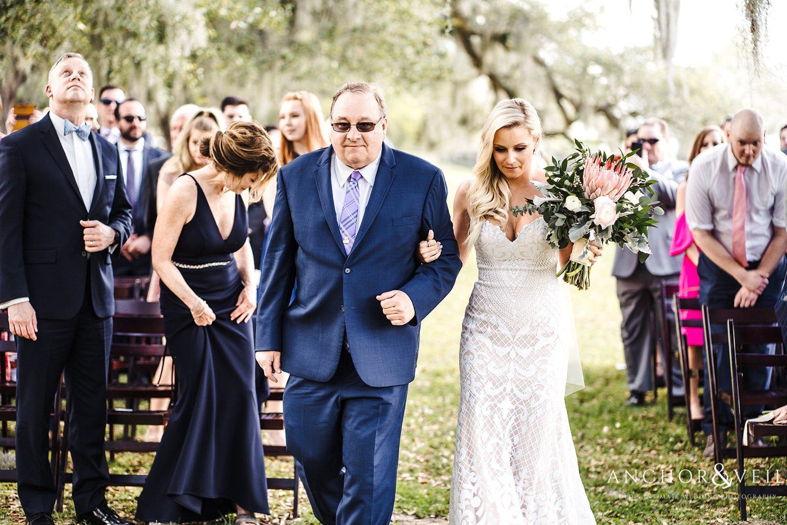 The bride walking down the aisle with her father at the Boone Hall Plantation Wedding 