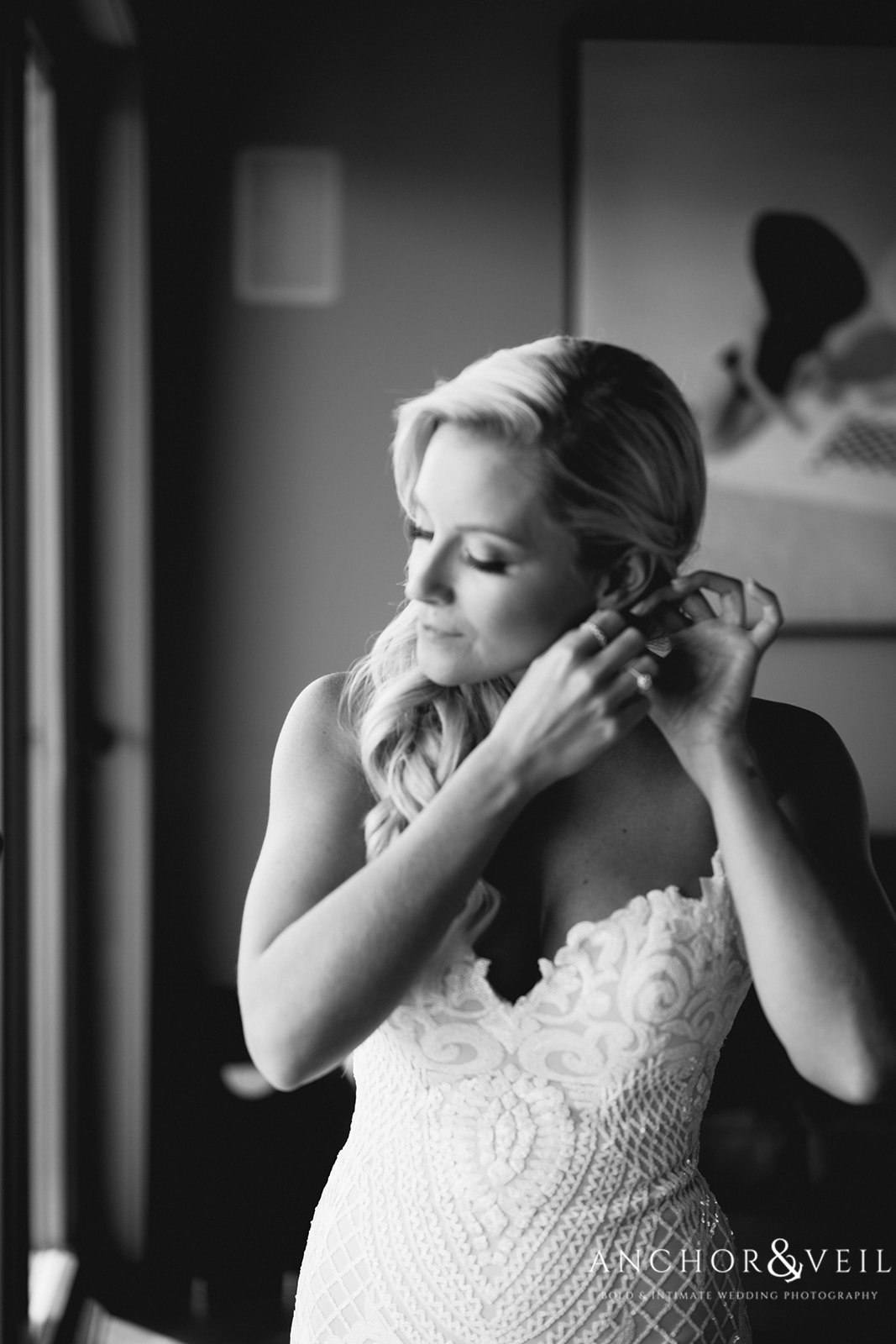 The bride putting on her earrings at the Boone Hall Plantation Wedding 