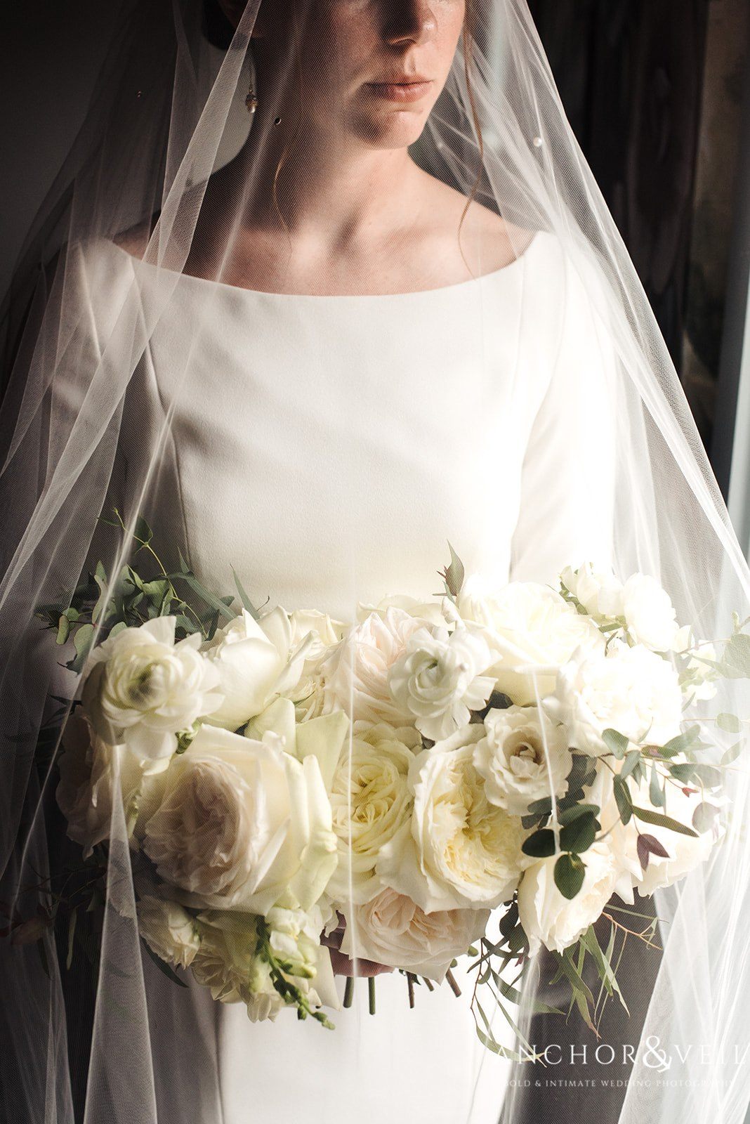 The bride under the veil with bridal bouquet at the Circle M Farms Wedding