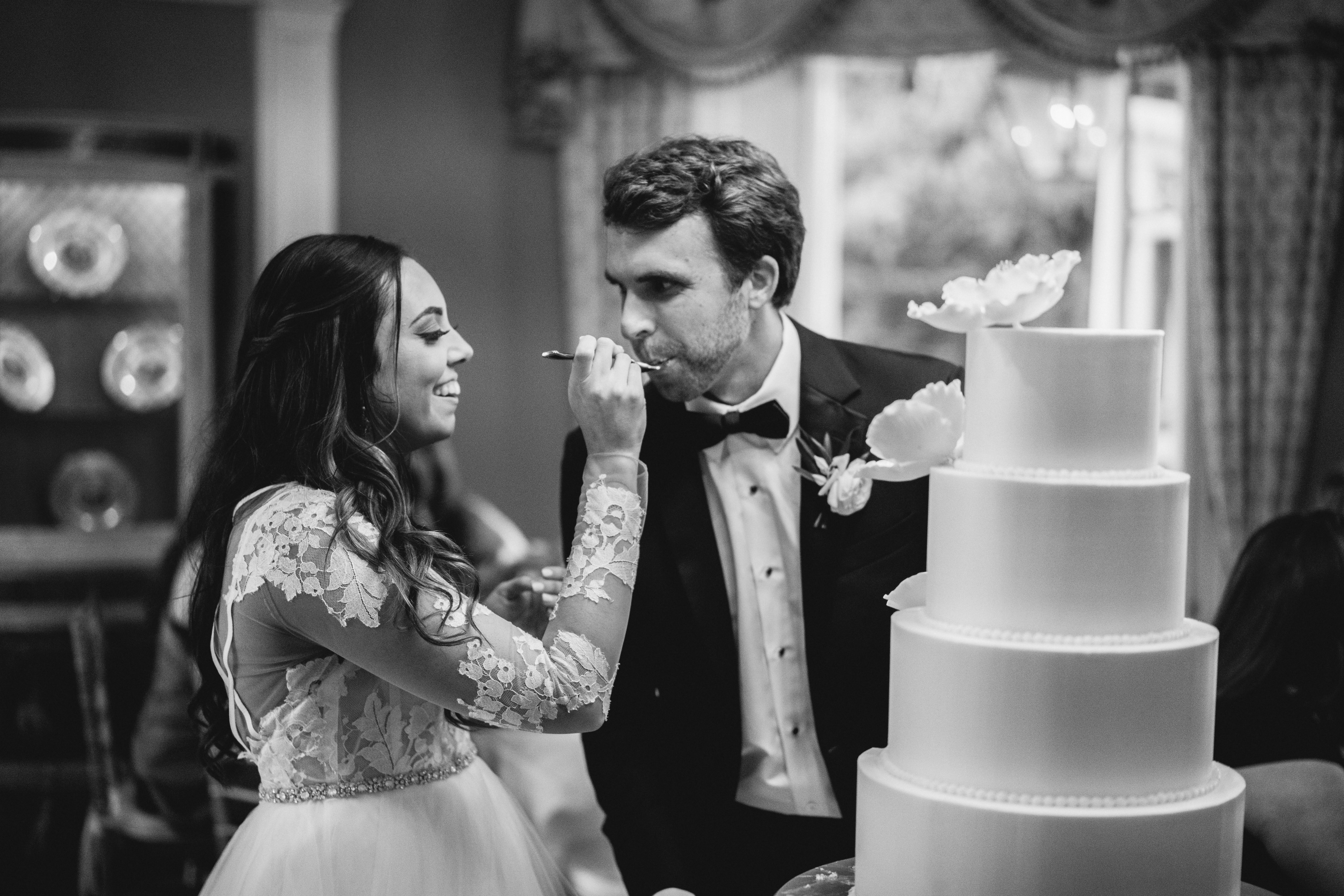 The bride and groom eating cake at the William Aiken House Wedding
